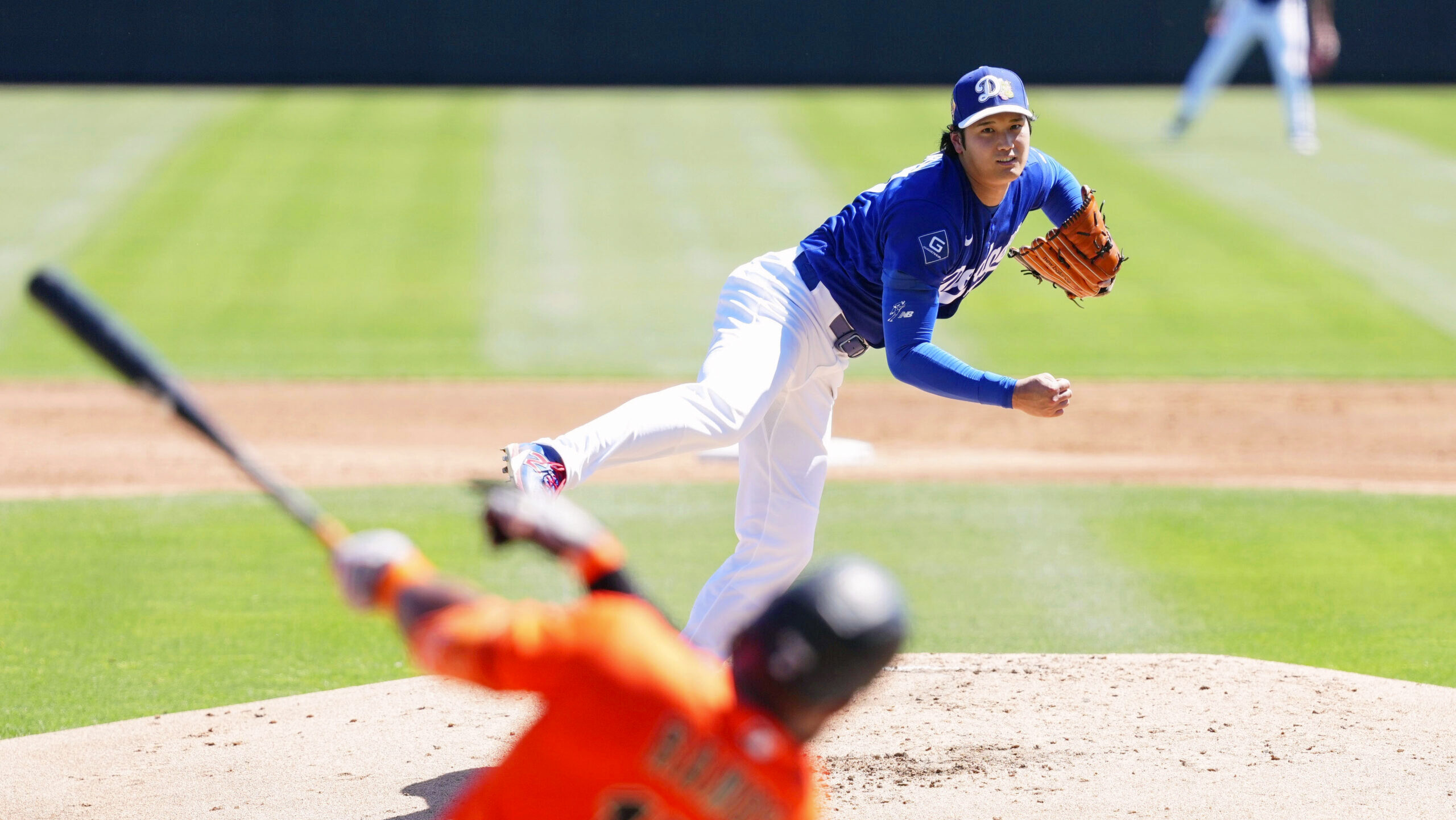 Two-way player Shohei Ohtani of the MLB's Los Angeles Dodgers is shown throwing a pitch against the San Francisco Giants.