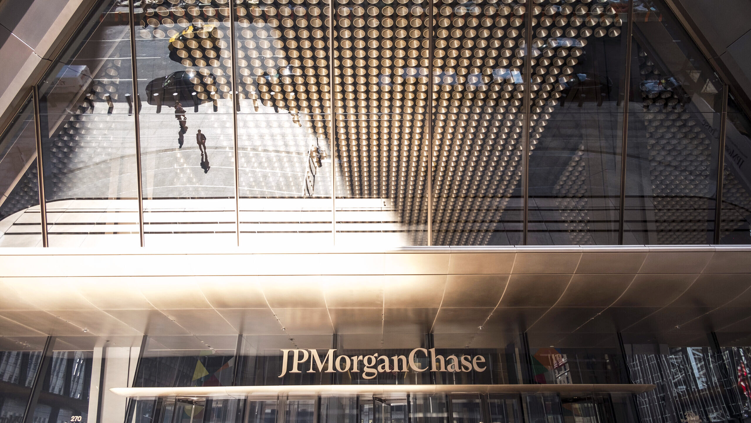 The main entrance of the JP Morgan Chase building in New York City is shown, with the bank's logo in view.