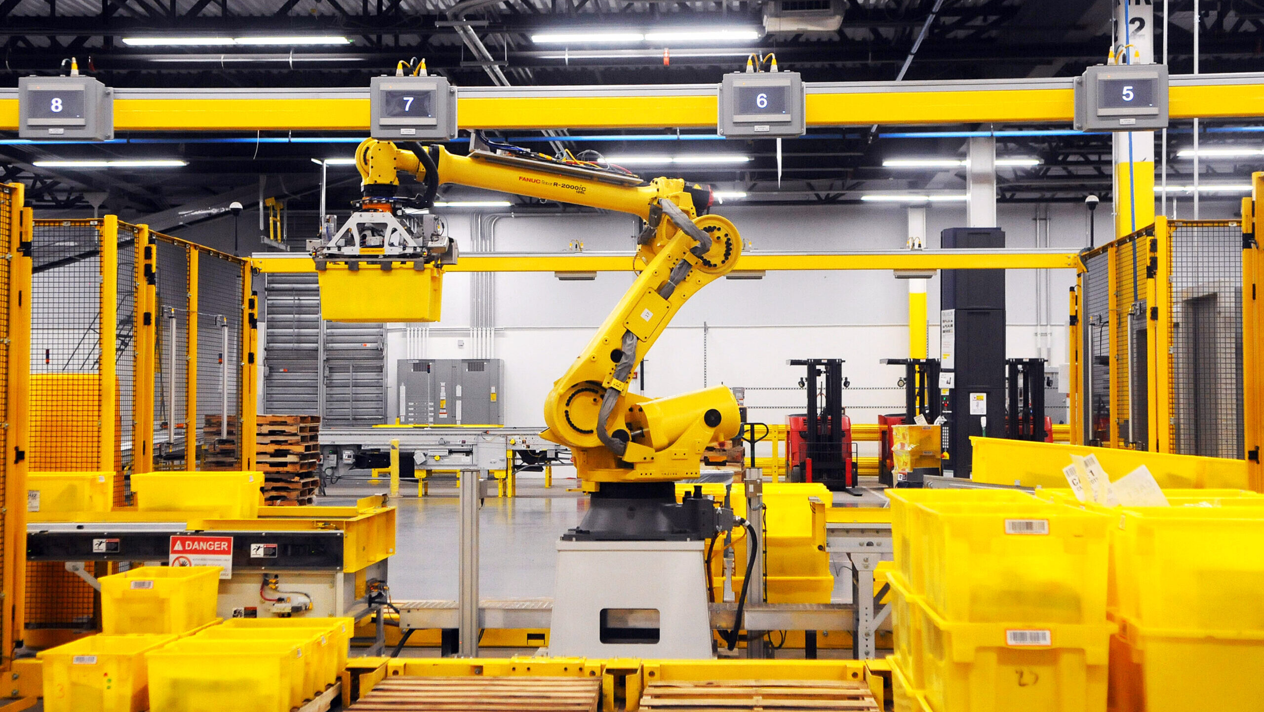 Photo of a robot arm at an Amazon fulfillment center.