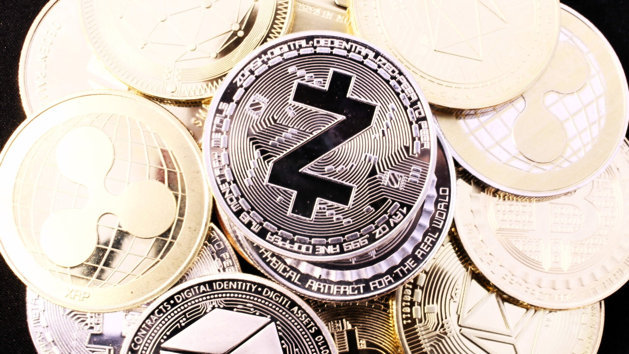 Photo of a Zcash "coin" in a pile of other cryptocurrency "coins."