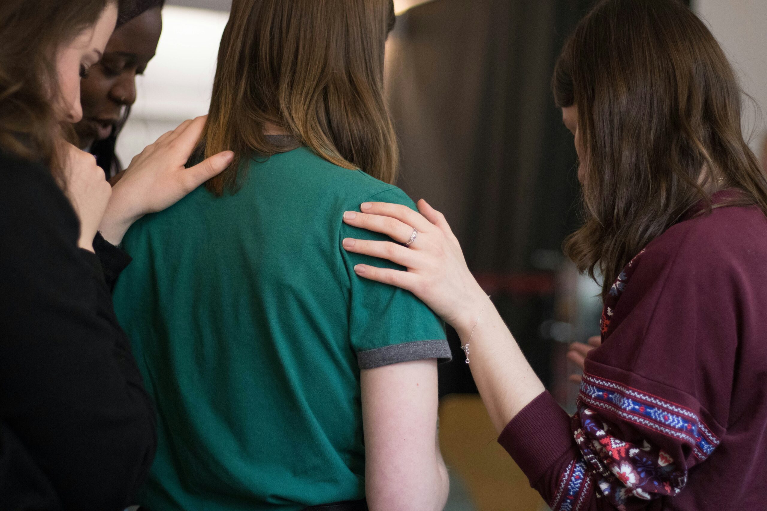 A group of women comforting one another.