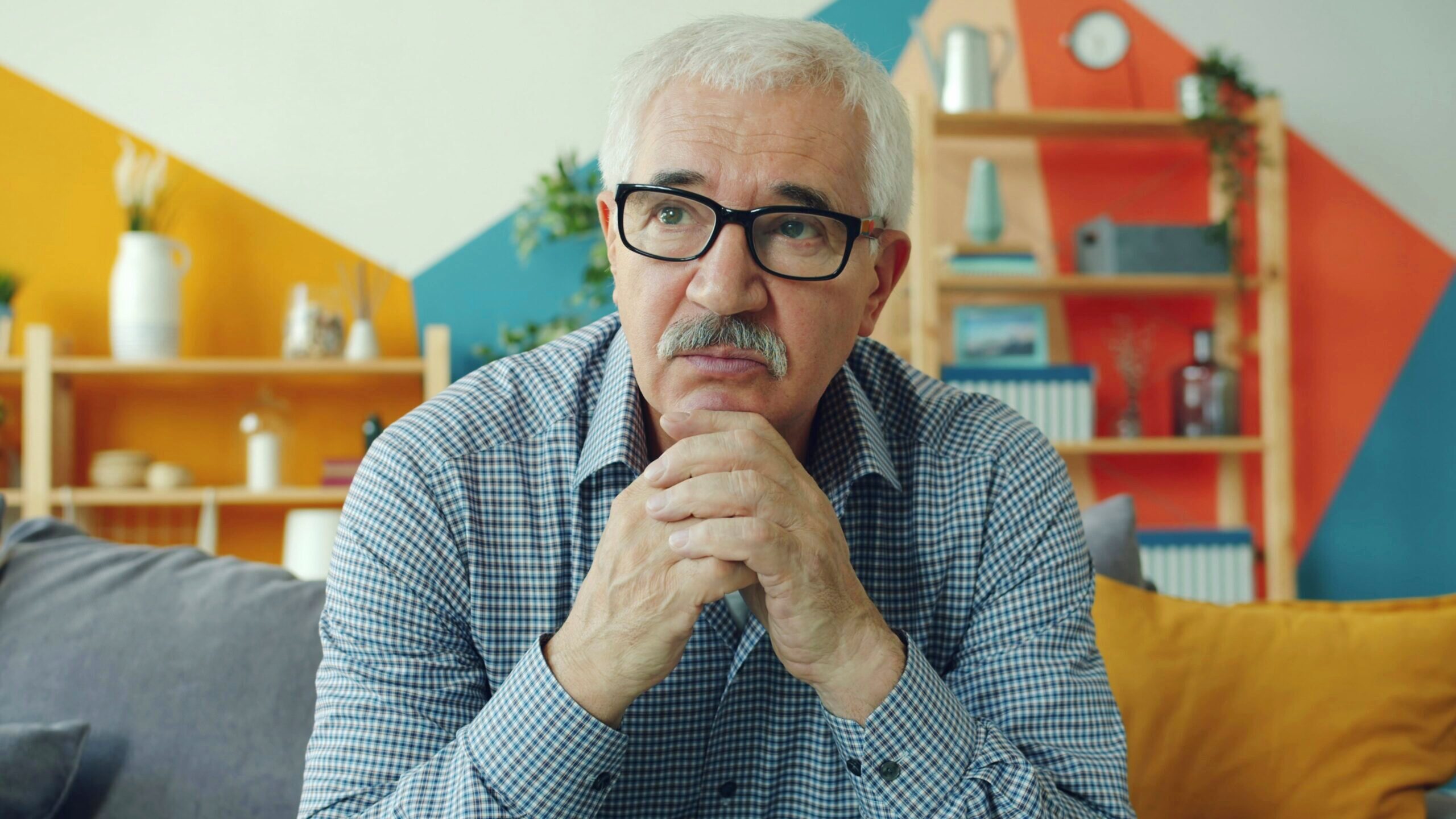 Photo of older man looking slightly concerned.