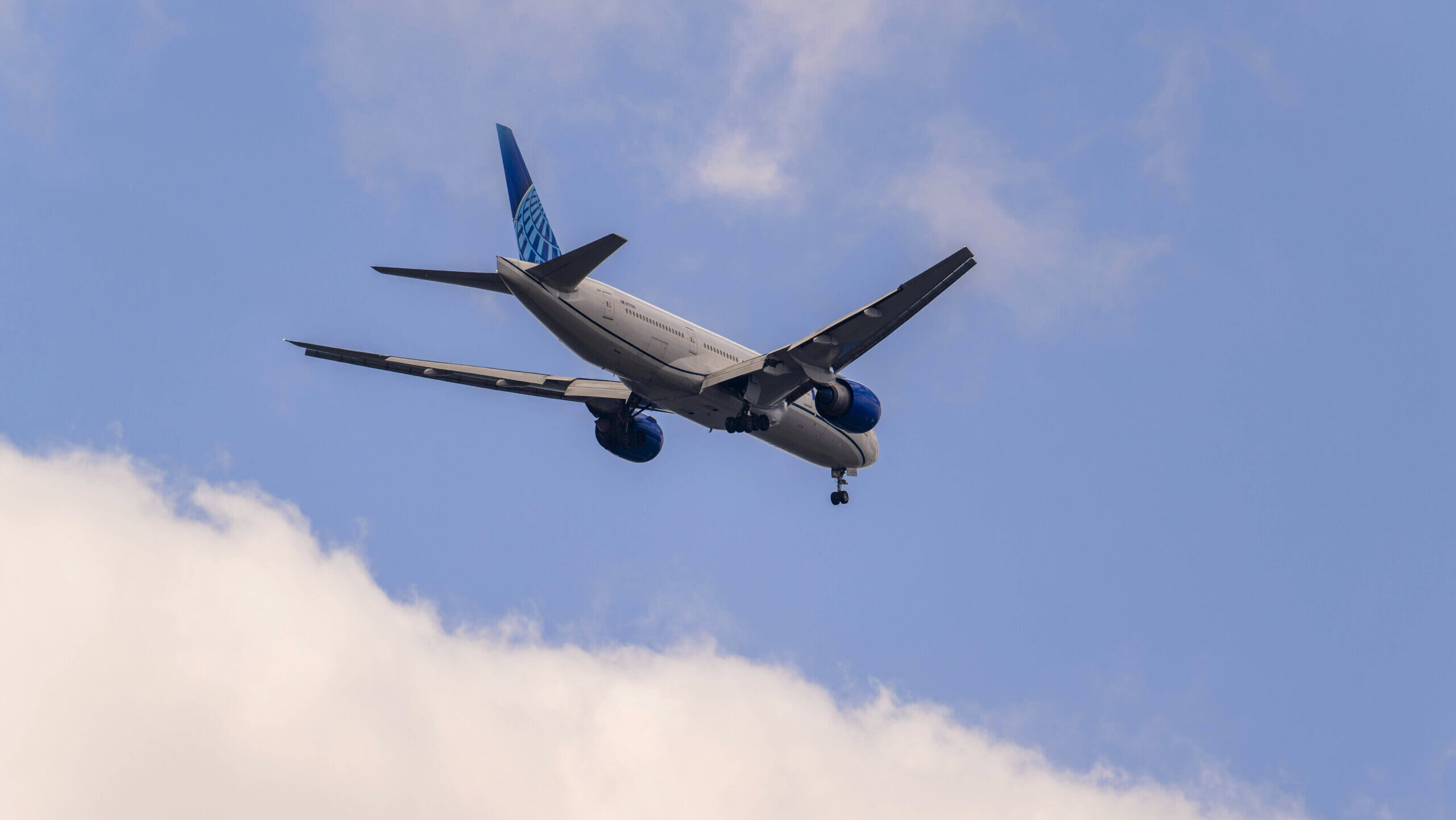 Photo of a United Airlines plane mid-flight.