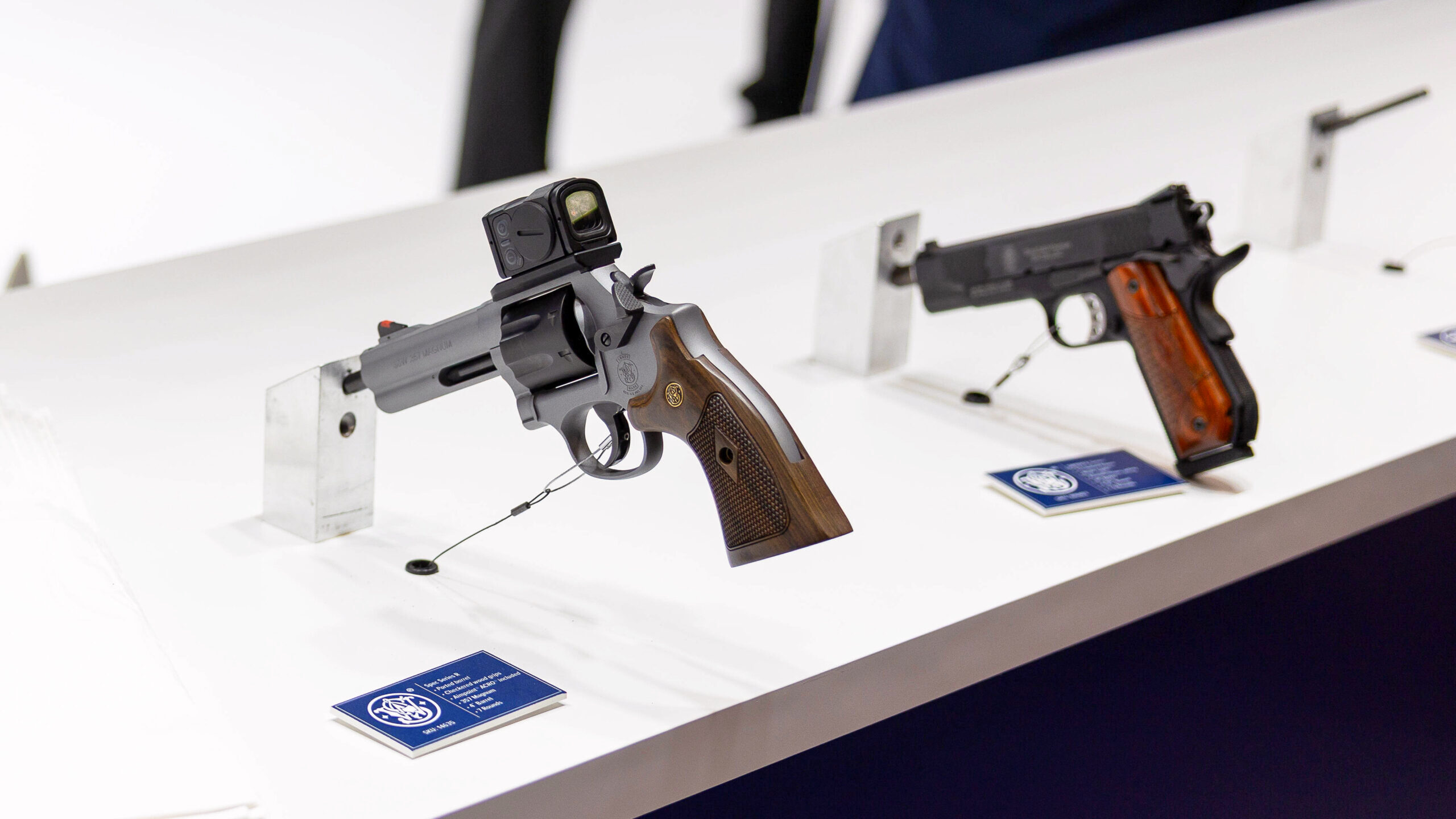 Photo of Smith & Wesson firearms on display at a trade show.