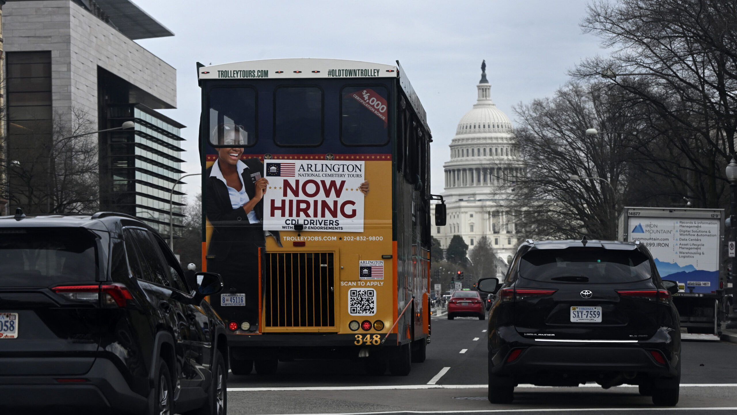 A "Now Hiring" sign is display on a tour bus on March 11, 2026 in Washington, DC.