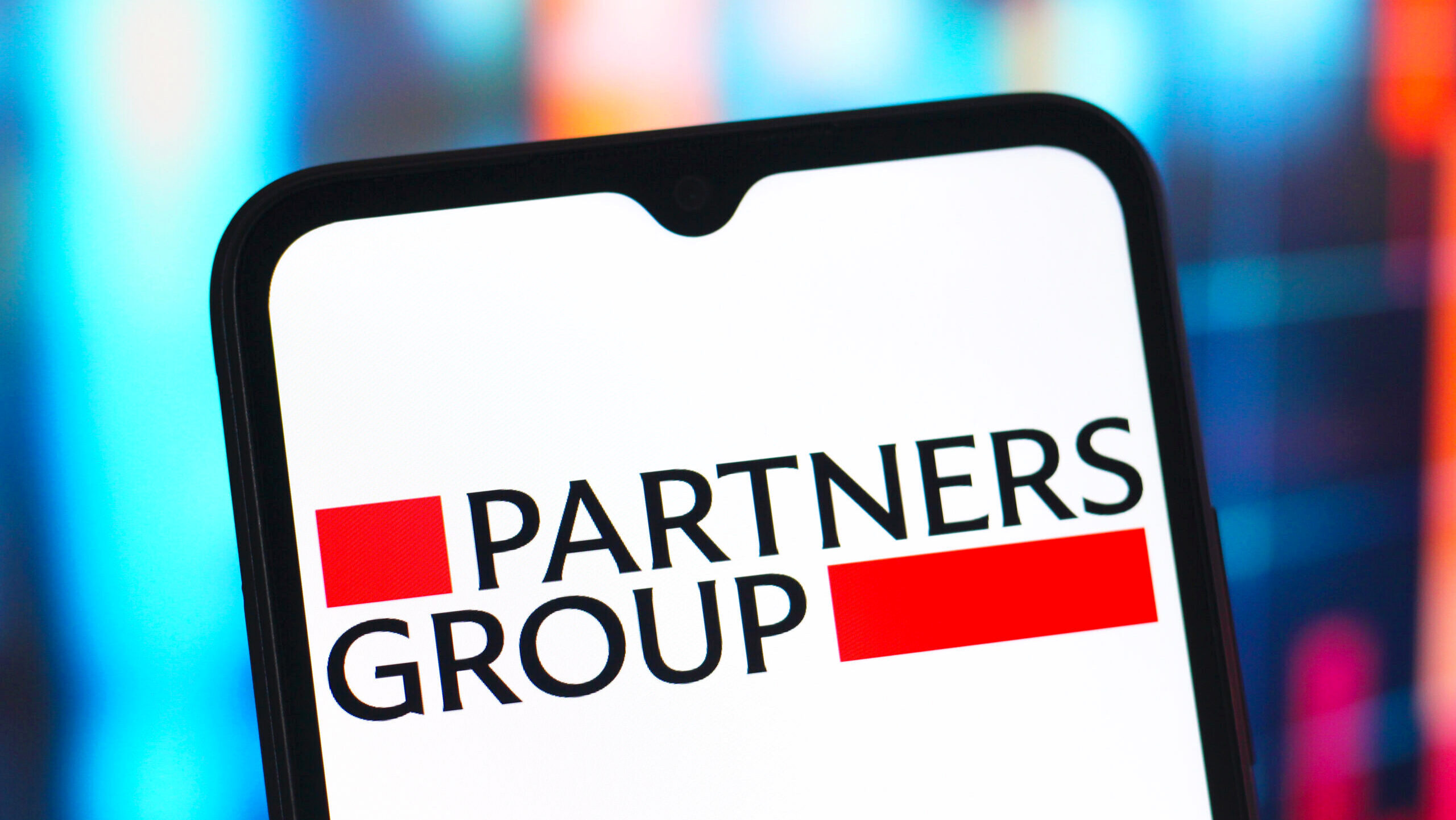 Photo of the Partners Group logo on a smartphone.