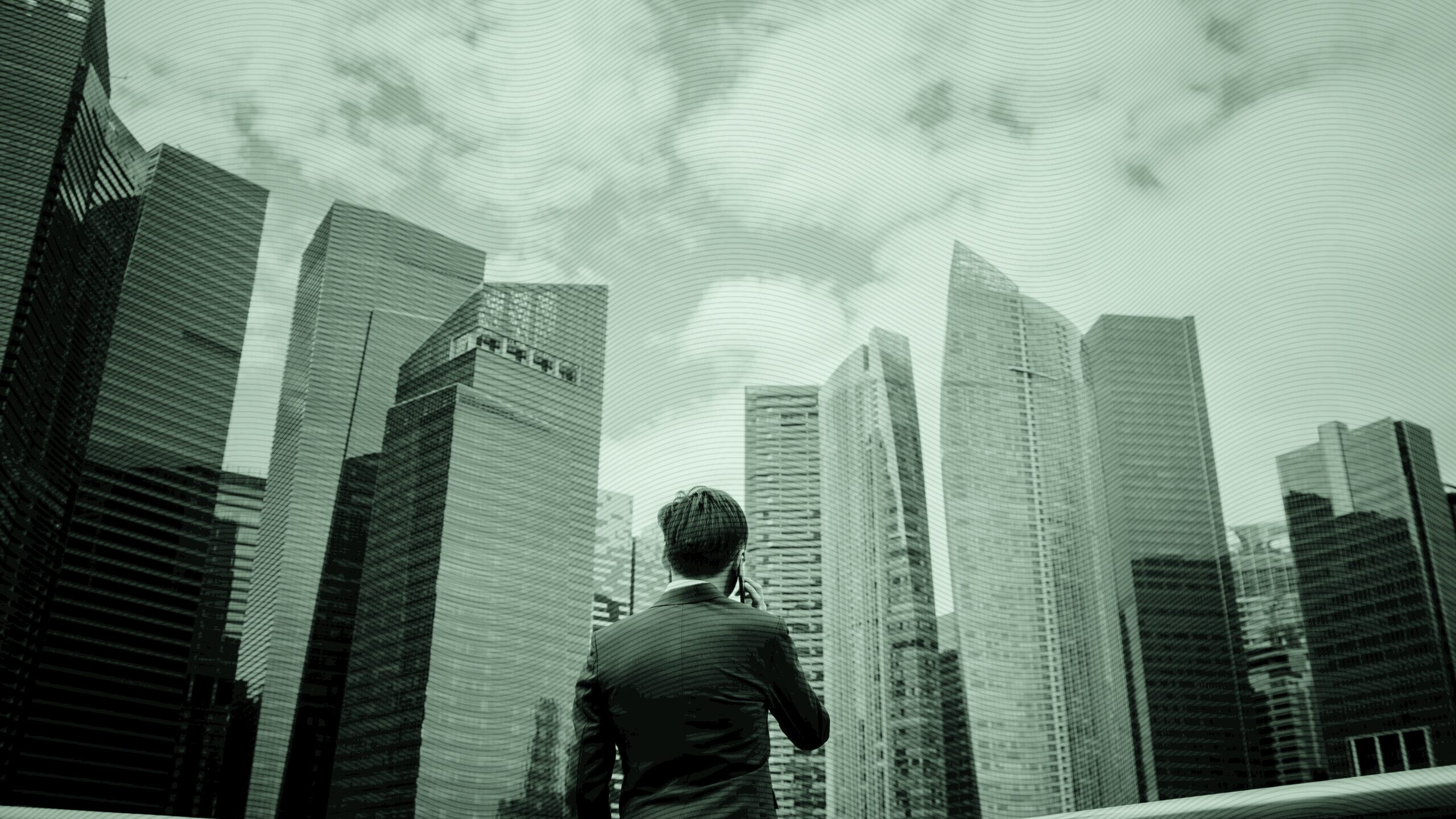 A man staring at skyscrapers.