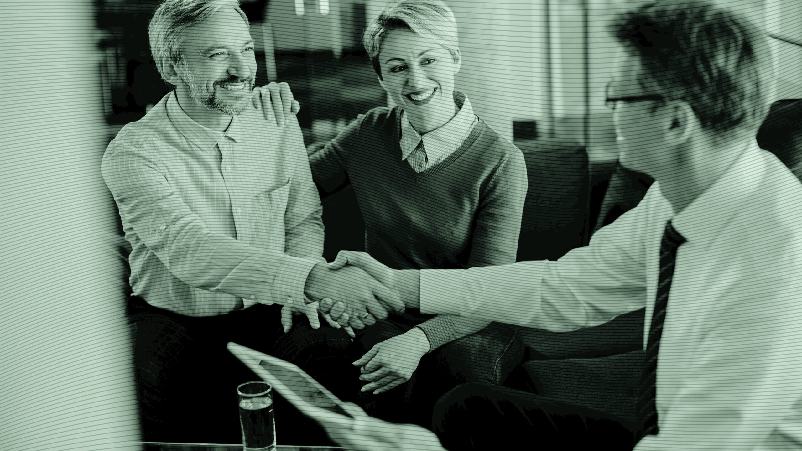 A client and advisor shaking hands.