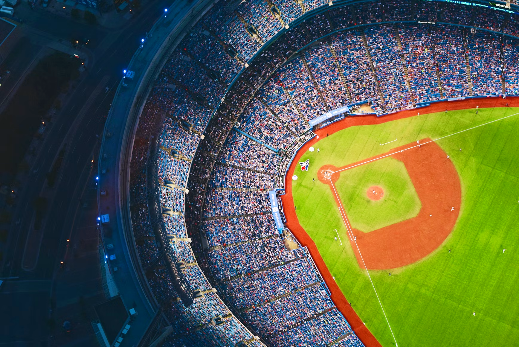 Overhead areal photo of a baseball stadium full of people.