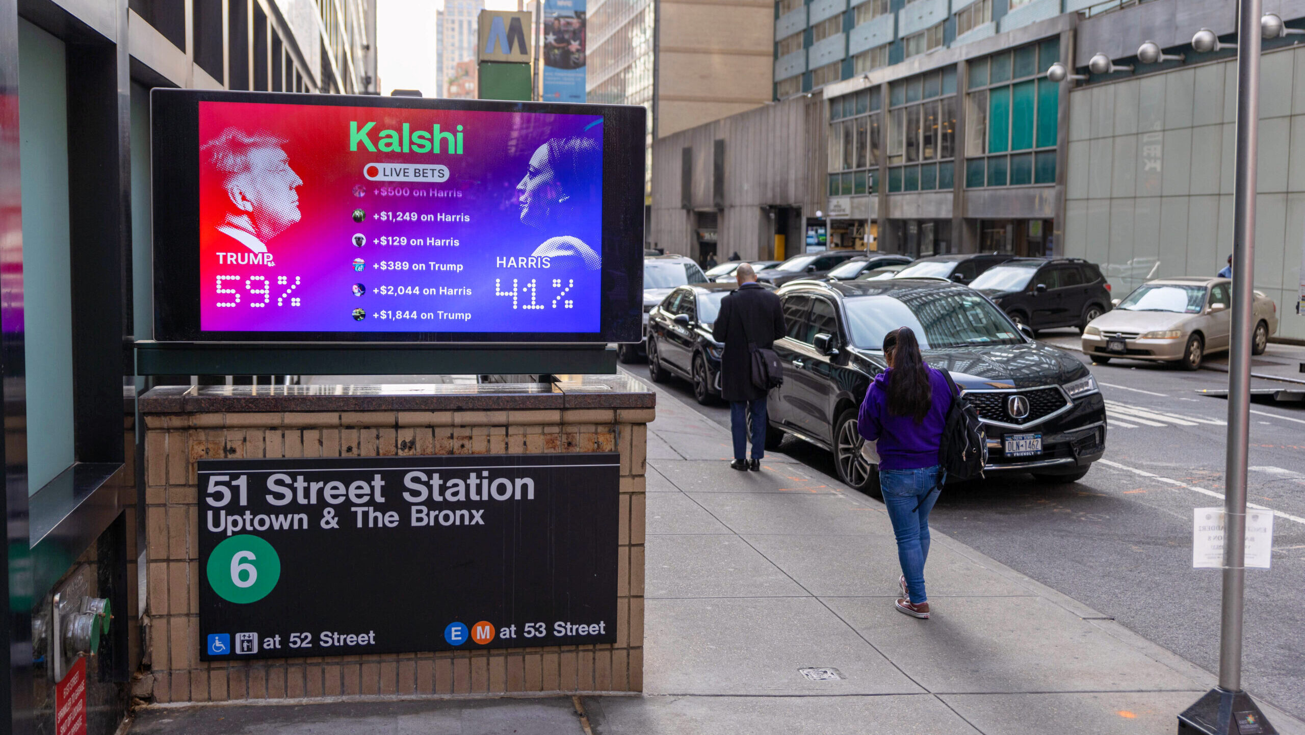 Photo of a street display showing Kalshi live betting odds on the results of the 2024 US presidential election.