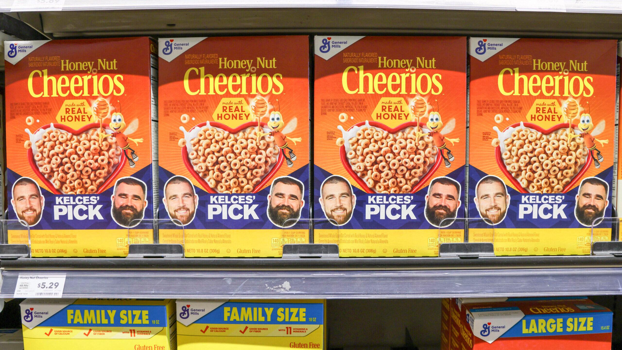 Photo of boxes of Honey Nut Cheerios on grocery store shelves.